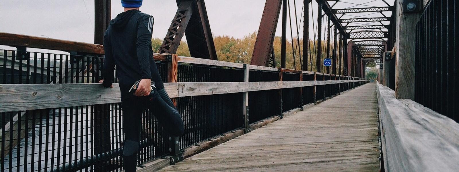 Man Standing on Bridge